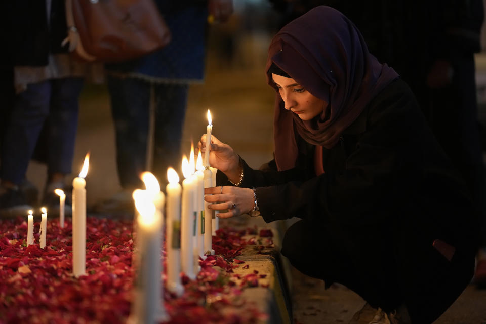 <p>A woman light candles during a candle light vigil for the victims of earthquake in Syria and Turkey, in Islamabad, Pakistan, Monday, Feb. 6, 2023. A powerful 7.8 magnitude earthquake has rocked wide swaths of Turkey and Syria. It toppled hundreds of buildings and killed more than 1,900 people. Hundreds are still believed to be trapped under rubble, and the toll is expected to rise as rescue workers search mounds of wreckage in cities and towns across the area. (AP Photo/Anjum Naveed)</p> 
