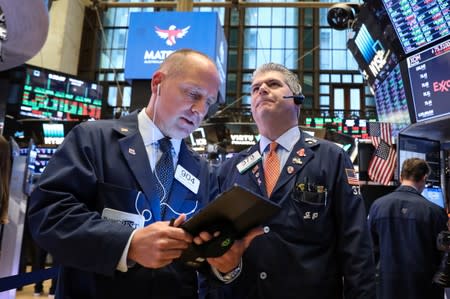 Traders work on the floor at the NYSE in New York