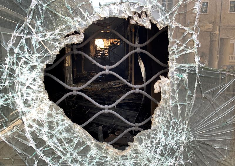 FILE PHOTO: A view shows shattered glass of an abandoned bank branch that was set ablaze during overnight protests in Beirut