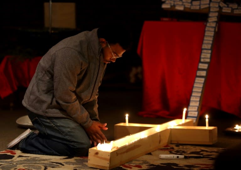 Participants in a vigil at Jacob's Porch are seen praying following the car and knife attack on the campus of Ohio State University in Columbus, Ohio, earlier November 28, 2016