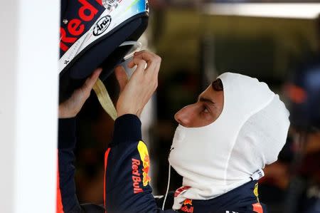 Formula One - F1 - Australian Grand Prix - Melbourne, Australia - 25/03/2017 Red Bull Racing driver Daniel Ricciardo of Australia dons his helmet during the third practice session. REUTERS/Brandon Malone