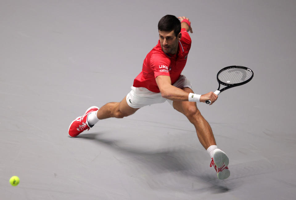 INNSBRUCK, AUSTRIA - NOVEMBER 27: Novak Djokovic of Serbia stretches to play a backhand shot during the Davis Cup match between Novak Djokovic of Serbia and Jan-Lennard Struff of Germany at OlympiaWorld on November 27, 2021 in Innsbruck, Austria. (Photo by Adam Pretty/Getty Images)