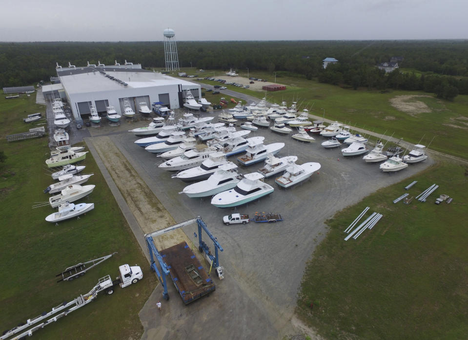 Boats are removed from the water at Winters Yachts in Swansboro N.C. as Hurricane Dorian moves up the East coast on Wednesday, Sept. 4, 2018. (AP Photo/Tom Copeland)