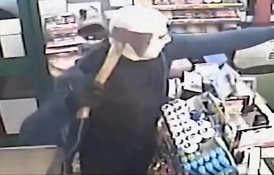 The robbers stormed into GMP Off Licence in Wednesfield, West Midlands, on December 17 (Picture: SWNS)