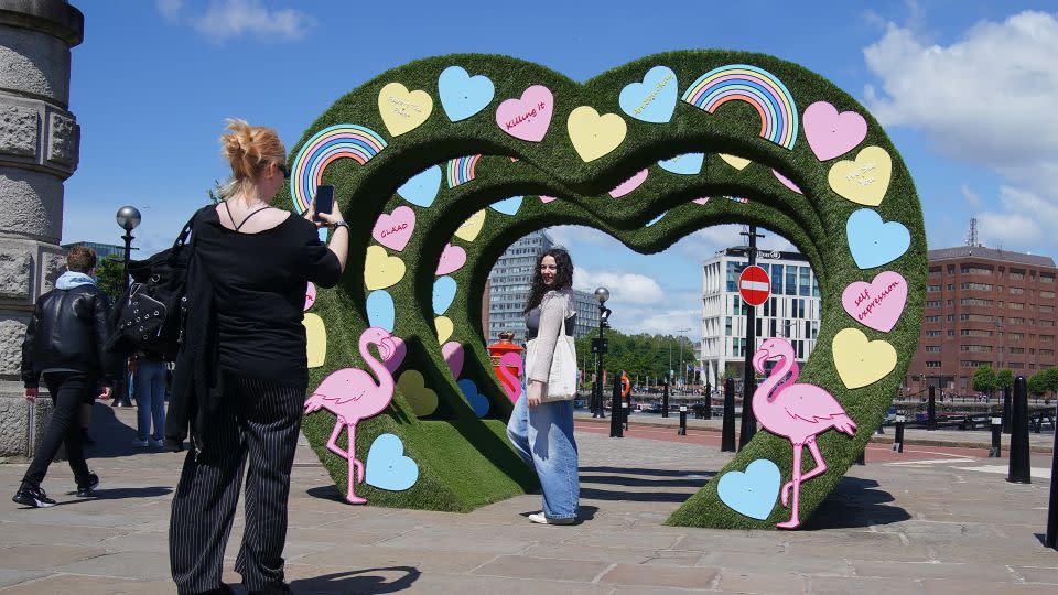 A fan poses at an art installation representing Taylor Swift's "Lover" album era, in Liverpool in June 2024. - Peter Byrne/PA Images/Getty Images