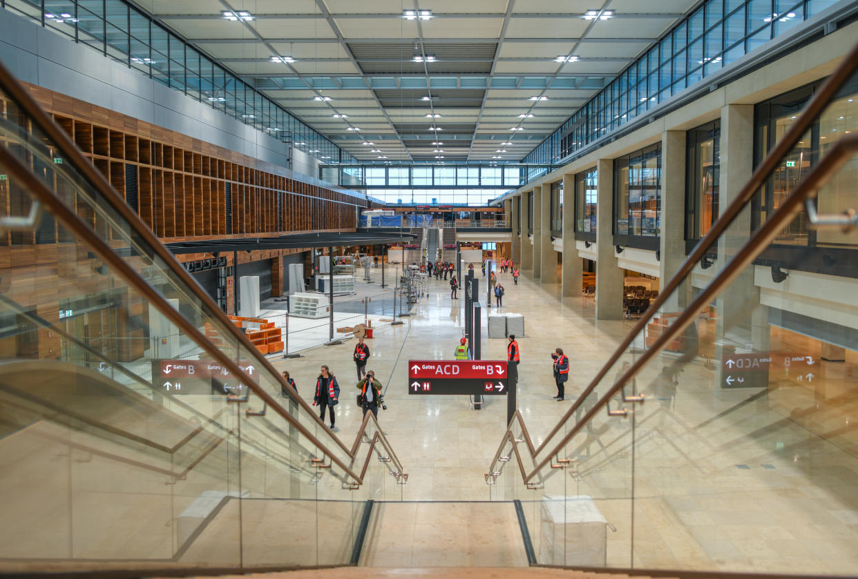 25 November 2019, Brandenburg, Schönefeld: Journalists walk through the terminal building of Berlin Brandenburg Airport Willy Brandt (BER). Photo: Patrick Pleul/dpa-Zentralbild/ZB (Photo by Patrick Pleul/picture alliance via Getty Images)