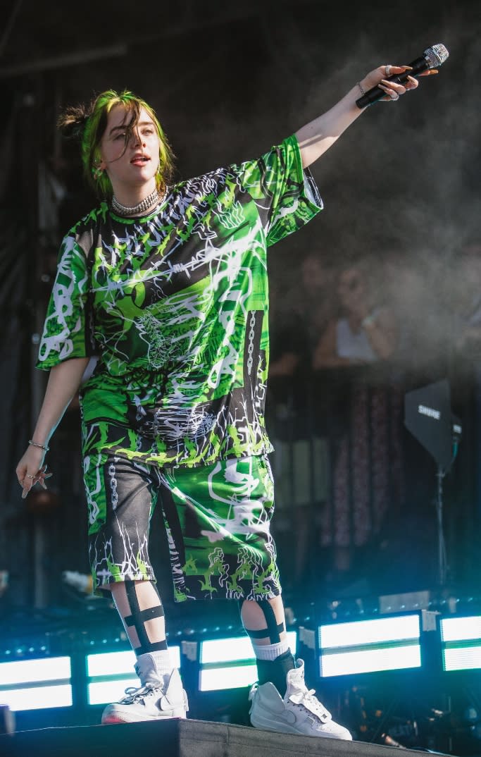 Billie Eilish performs in a bold green look at the 2019 Reading Festival on Aug 24. - Credit: Shutterstock