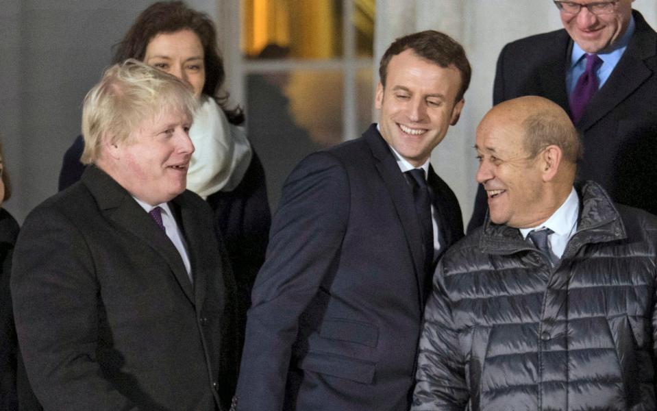  Foreign Secretary Boris Johnson with French President Emmanuel Macron and Laurent Fabius, prepare for a group photo during UK-France summit talks at the Royal Military Academy Sandhurst, in Camberley - Pool PA