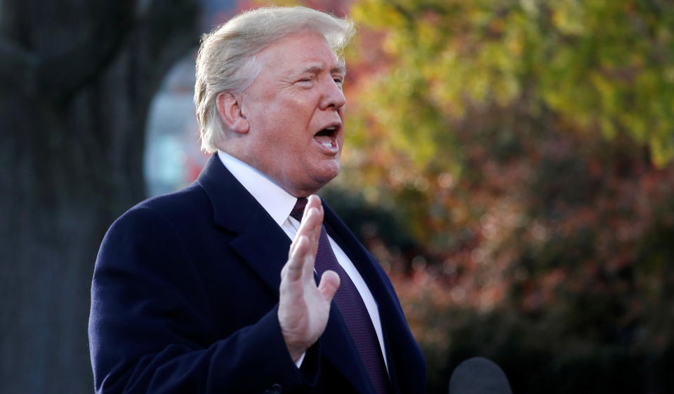 President Trump speaks to reporters while walking to board Marine One to depart for Mar-a-Lago from the White House on Tuesday. (Photo: Leah Millis/Reuters)