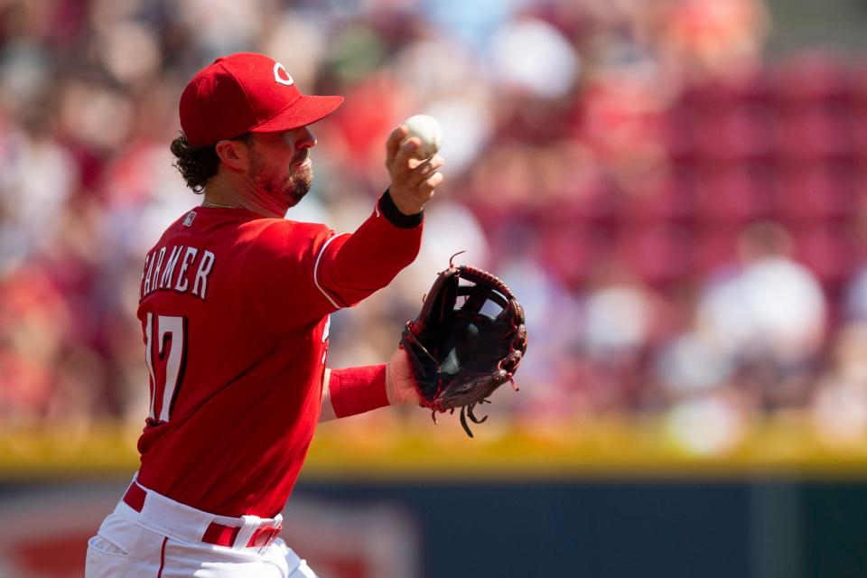 Cincinnati Reds shortstop Kyle Farmer (17) throws to first for an out in the first inning of the MLB game between the Cincinnati Reds and the Atlanta Braves at Great American Ball Park in Cincinnati on Saturday, July 2, 2022.