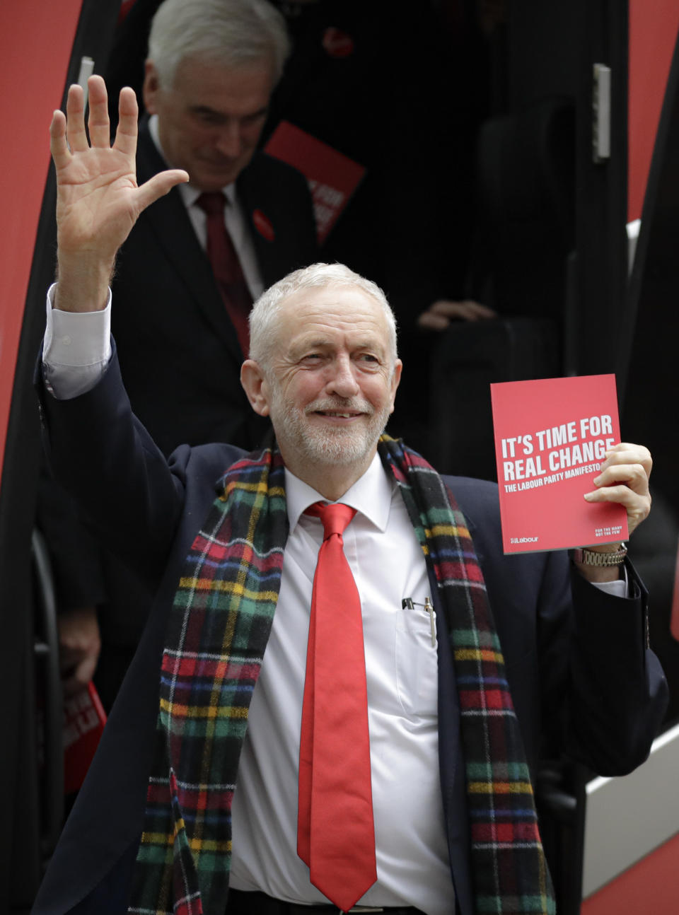 Jeremy Corbyn, Leader of Britain's opposition Labour Party waves upon arriving for the launch of Labour's General Election manifesto, at Birmingham City University, England, Thursday, Nov. 21, 2019. Britain goes to the polls on Dec. 12. (AP Photo/Kirsty Wigglesworth)