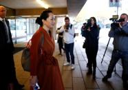 Huawei Technologies Chief Financial Officer Meng Wanzhou holds a Huawei cellphone as she leaves for a lunch break during a hearing at British Columbia supreme court in Vancouver