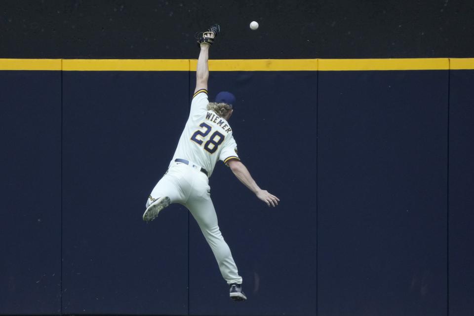 Milwaukee Brewers' Joey Wiemer can't catch a double hit by Chicago Cubs' Dansby Swanson during the second inning of a baseball game Monday, July 3, 2023, in Milwaukee. (AP Photo/Morry Gash)