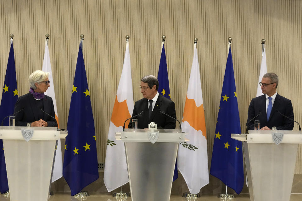 President of the European Central Bank Christine Lagarde, left, Cyprus President Nicos Anastasiades, center, and the Governor of Central Bank of Cyprus Constantinos Herodotou talk to the media during a press conference after their meeting at the Presidential Palace in the capital Nicosia, Cyprus, Wednesday, March 30, 2022. Lagarde is visiting European Union member Cyprus amid the country's continuing efforts to buttress its banking system following a 2013 financial crisis that nearly brought the island nation to bankruptcy. (AP Photo/Petros Karadjias)