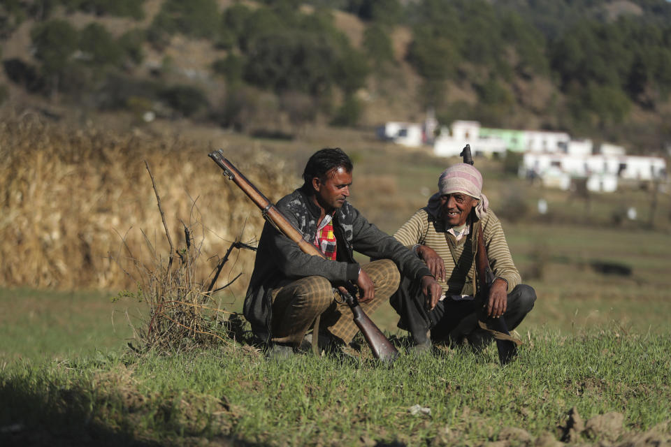 Members of a local militia called Village Defense Committees, that have been formed to aid the Indian army in keeping a close watch of the India-Pakistan border, rest near the Line of Control, at Jhangad Village in Naushera, India, Thursday, Dec. 17, 2020. From sandbagged Indian army bunkers dug deep into the Pir Panjal mountains in the Himalayas, villages on the Pakistan-controlled side of Kashmir appear precariously close, on the other side of the Line of Control that for the past 73 years has divided the region between the two nuclear-armed rivals. Tens of thousands of soldiers from India and Pakistan are positioned along the two sides. The apparent calm is often broken by the boom of blazing guns, with each side accusing the other of initiating the firing. (AP Photo/Channi Anand)