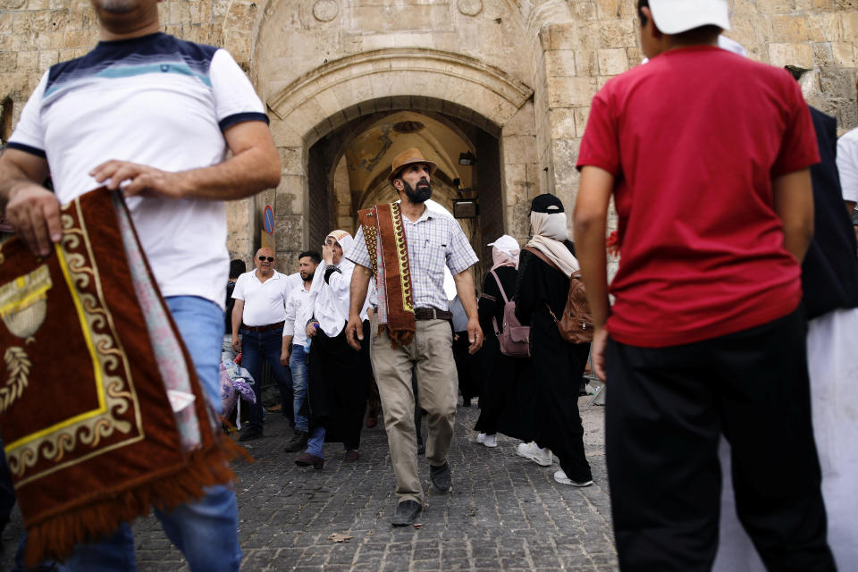 A Muslim man carries a prayer mat as he walks near Lions' Gate in Jerusalem's Old City. (Photo: Nir Elias/Reuters)