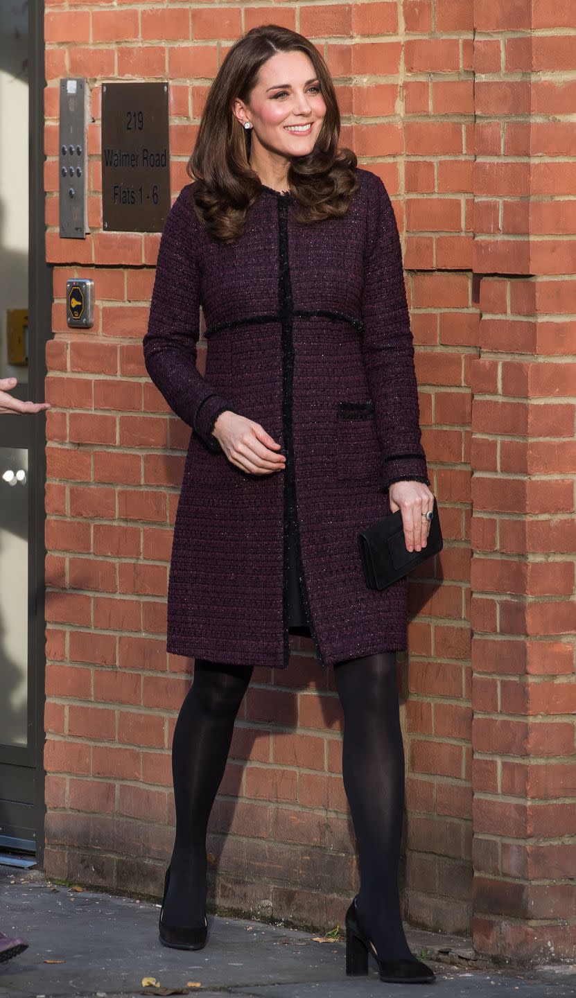 <p>The Duchess wears a plum Seraphine maternity coat, black tights, black pumps, and a black clutch during while visiting the 'Magic Mums' community Christmas party held at Rugby Portobello Trust in London.</p>