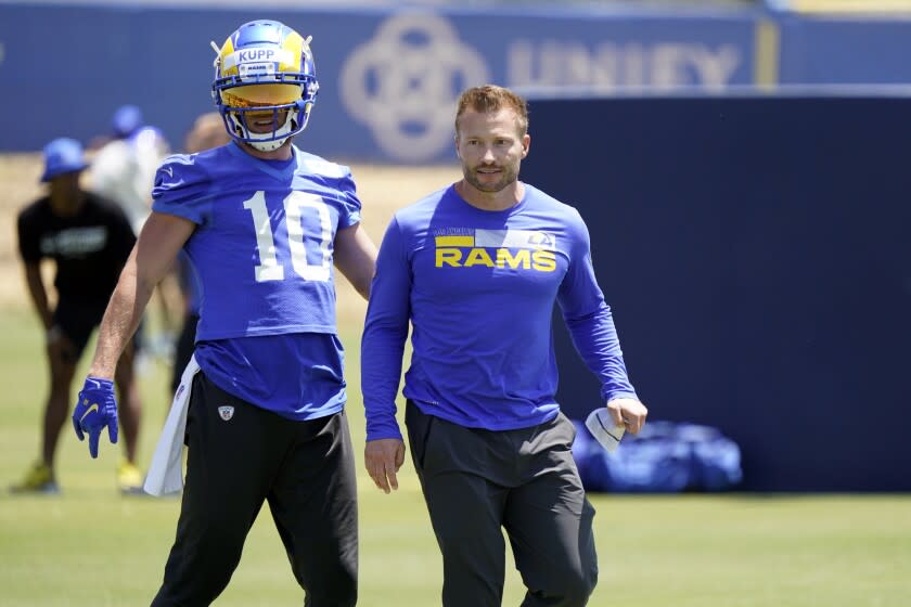 Los Angeles Rams wide receiver Cooper Kupp, right, stands next to head coach Sean McVay at the NFL football team's practice facility Thursday, May 26, 2022, in Thousand Oaks, Calif. (AP Photo/Marcio Jose Sanchez)