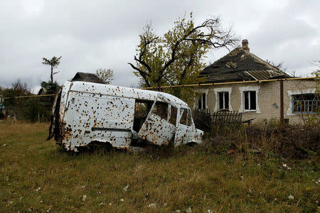 A vehicle damaged by shrapnel and an explosive wave, sits abandoned in the Oktyabrsky district in Donetsk, Ukraine, November 1, 2017. REUTERS/Alexander Ermochenko