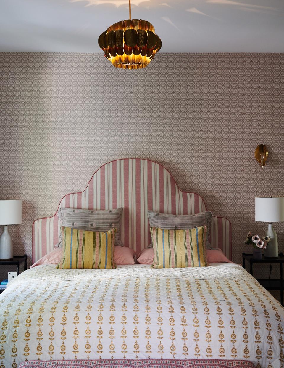 The guest bedroom is a study in prints. The wallpaper is from Lee Jofa and paired with a headboard from Claremont and bed linens from Les Indiennes. The bedside tables are vintage from Nickey Kehoe with lamps from Lawson Fenning.