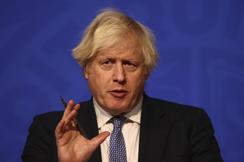 Britain's Prime Minister Boris Johnson speaks at a press conference in London's Downing Street, Wednesday Dec. 8, 2021, after ministers met to consider imposing new restrictions in response to rising cases and the spread of the omicron variant. (Adrian Dennis/Pool via AP)