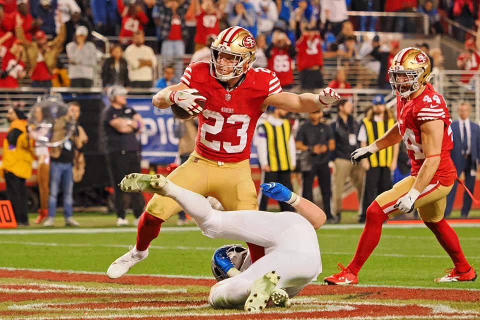 San Francisco 49ers running back Christian McCaffrey (23) runs with the ball for a touchdown against the Detroit Lions during the second half of the NFC Championship football game at Levi's Stadium.