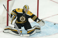 Boston Bruins' Jeremy Swayman stops the puck in the first period of Game 4 of an NHL hockey Stanley Cup first-round playoff series against the Carolina Hurricanes, Sunday, May 8, 2022, in Boston. The Bruins won 5-2. (AP Photo/Steven Senne)