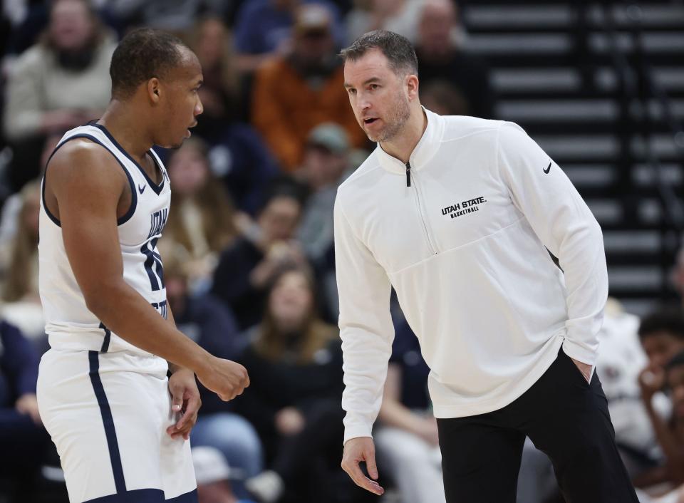 Utah State Aggies head coach Danny Sprinkle talks with guard Darius Brown II (10) against San Francisco Dons at the Delta Center in Salt Lake City on Saturday, Dec. 16, 2023. | Jeffrey D. Allred, Deseret News