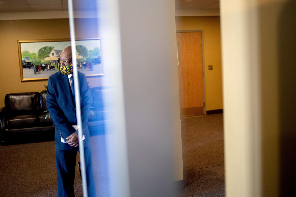 Funeral home worker Kelvin Young looks to the entrance as he waits to greet family and friends who arrive for the visitation of Calvin Munerlyn on Friday, May 8, 2020 at Sheldon T. Banks Funeral Chapel in Flint, Mich. Munerlyn, 43, of Flint was shot at the Family Dollar store following an alleged verbal altercation with 45-year-old Sharmel Teague after he told the woman's daughter she needed to wear a mask while inside. (Jake May/The Flint Journal, MLive.com via AP)