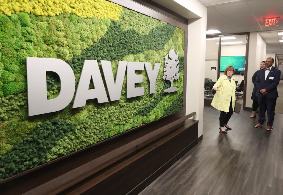 Molly Senter, director of properties at The Davey Tree Expert Company, shows the moss wall to State Sen. Vernon Sykes during a tour of the recently renovated headquarters and expanded facility in Kent.