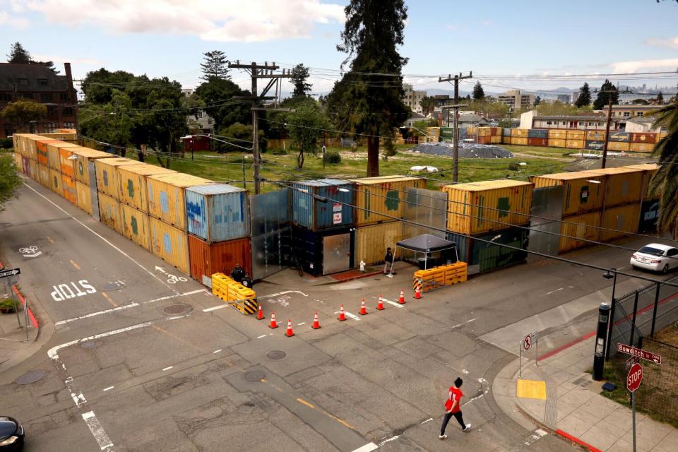 Cargo containers form a barrier around a park.