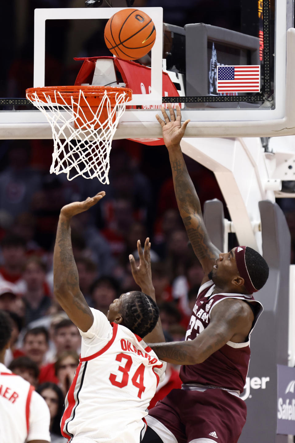 Texas A&M guard Tyrece Radford, right, shoots in front of Ohio State center Felix Okpara (34) during the second half of an NCAA college basketball game in Columbus, Ohio, Friday, Nov. 10, 2023. (AP Photo/Paul Vernon)