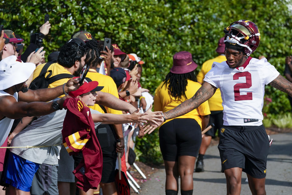 Washington Commanders wide receiver Dyami Brown (2) greats fans as he arrives for an NFL football practice at the team's training facility, Thursday, July 27, 2023, in Ashburn, Va. (AP Photo/Alex Brandon)