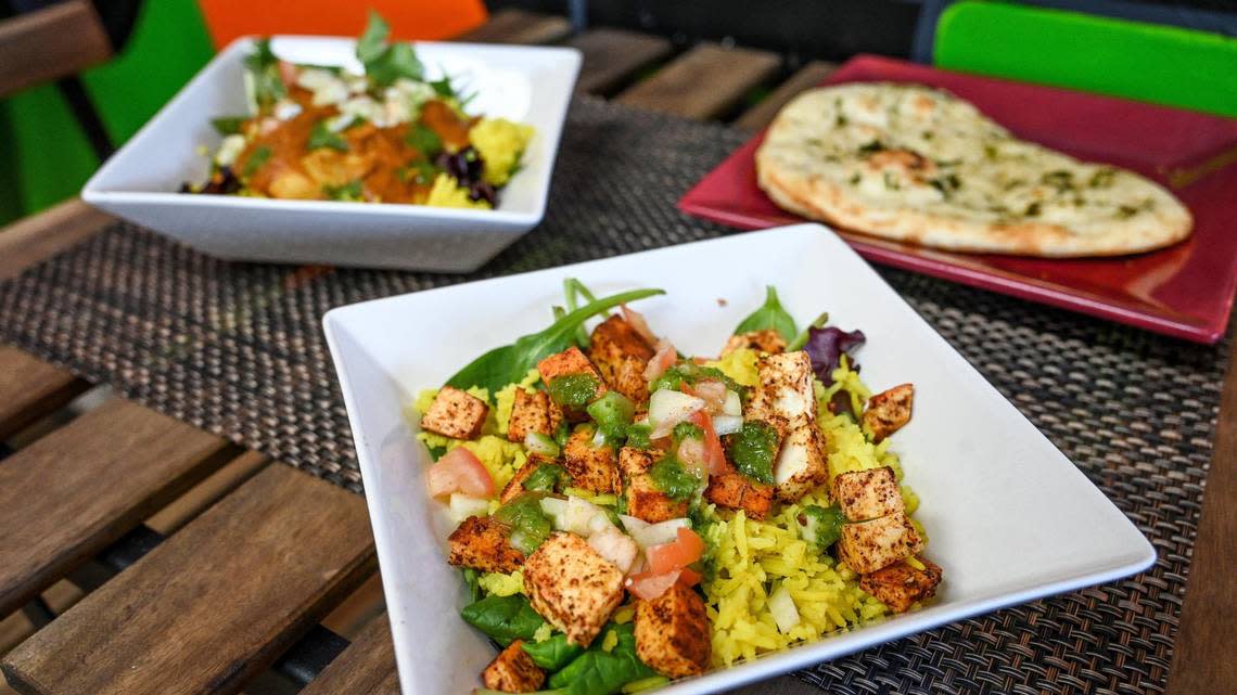 A pepper paneer dish, front, is photographed with chicken tikka masala and naan flatbread from The Curry Life in the space they share with Spicy Birdz and bubble Bee boba drinks in the Bluff View shopping center at Herndon and West in Fresno on Wednesday, Feb. 15, 2023.