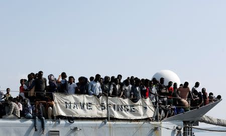 Migrants wait to disembark from the Italian Navy vessel Sfinge in the Sicilian harbour of Pozzallo, southern Italy, August 31, 2016. REUTERS/ Antonio Parrinello