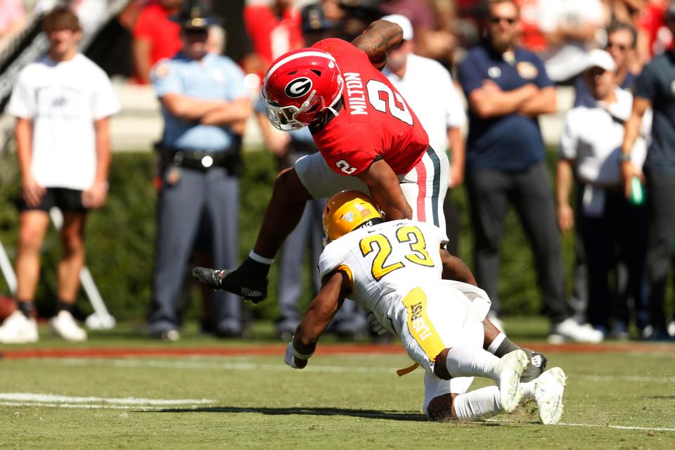 Kent State safety JoJo Evans (23) tackles Georgia running back Kendall Milton (2) as Georgia takes on Kent State at Sanford Stadium in Athens, Ga. on Saturday, Sept 24th, 2022.