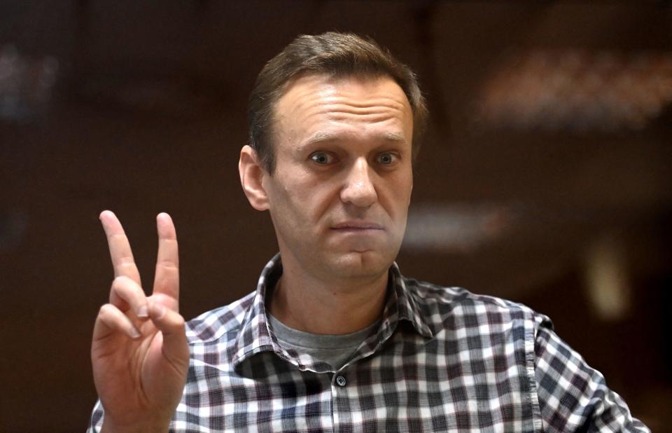TOPSHOT - Russian opposition leader Alexei Navalny stands inside a glass cell during a court hearing at the Babushkinsky district court in Moscow on February 20, 2021. The Kremlin's most prominent opponent Alexei Navalny faces two court decisions on Saturday that could seal a judge's ruling to jail him for several years, after he returned to Russia following a poisoning attack. (Photo by Kirill KUDRYAVTSEV / AFP) (Photo by KIRILL KUDRYAVTSEV/AFP via Getty Images)