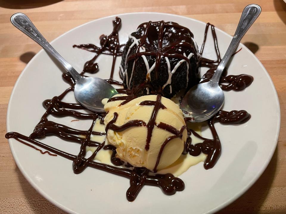 Triple-chocolate cake with a scoop of vanilla ice cream at Applebee's