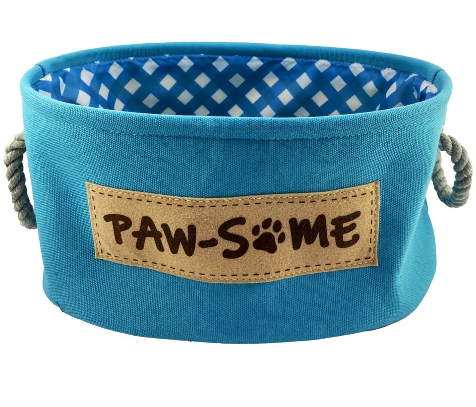 a canvas fabric pet caddy with "paw-some" written on it