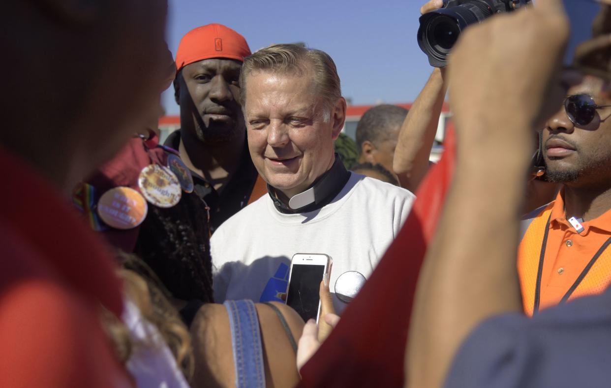 In this July 7, 2018 file photo, the Rev. Michael Pfleger speaks to protesters before marching on the Dan Ryan Expressway in Chicago. 