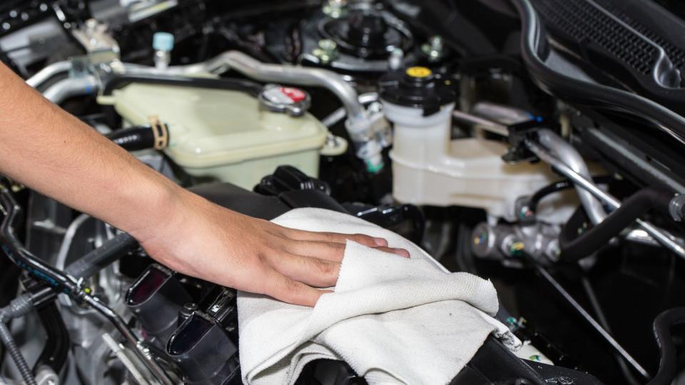 Cropped Image Of Mechanic Cleaning Engine