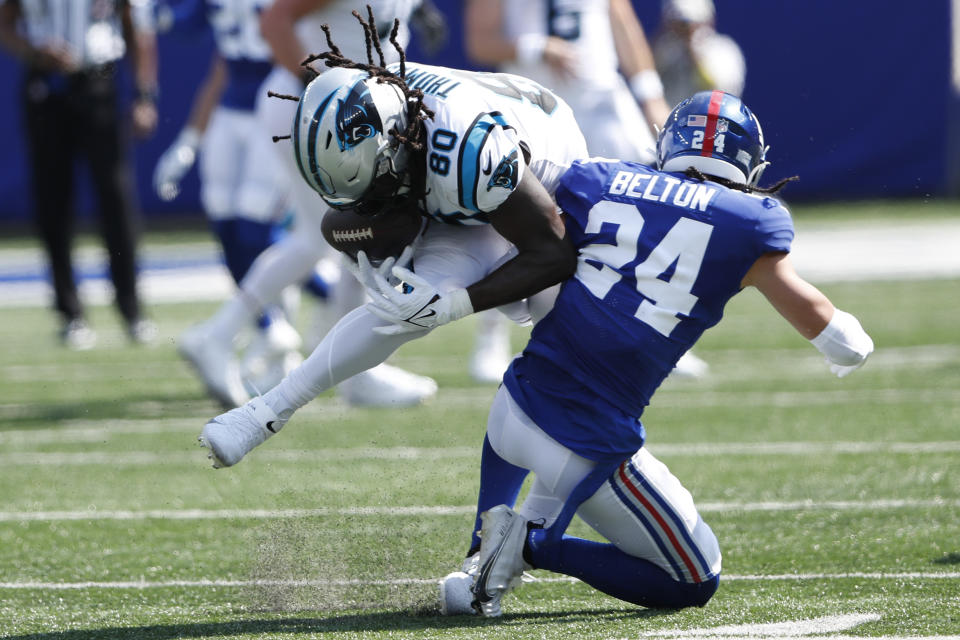 New York Giants' Dane Belton, right, tackles Carolina Panthers' Ian Thomas during the first half an NFL football game, Sunday, Sept. 18, 2022, in East Rutherford, N.J. (AP Photo/Noah K. Murray)