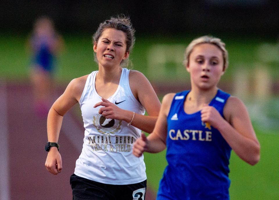 Central’s Emma McGee trails behind Castle’s Heidi Giannini for the 3200 meter run during the 2023 Southern Indiana Athletic Conference Girls Track & Field meet at Central High School in Evansville, Ind., Wednesday evening, May 3, 2023.
