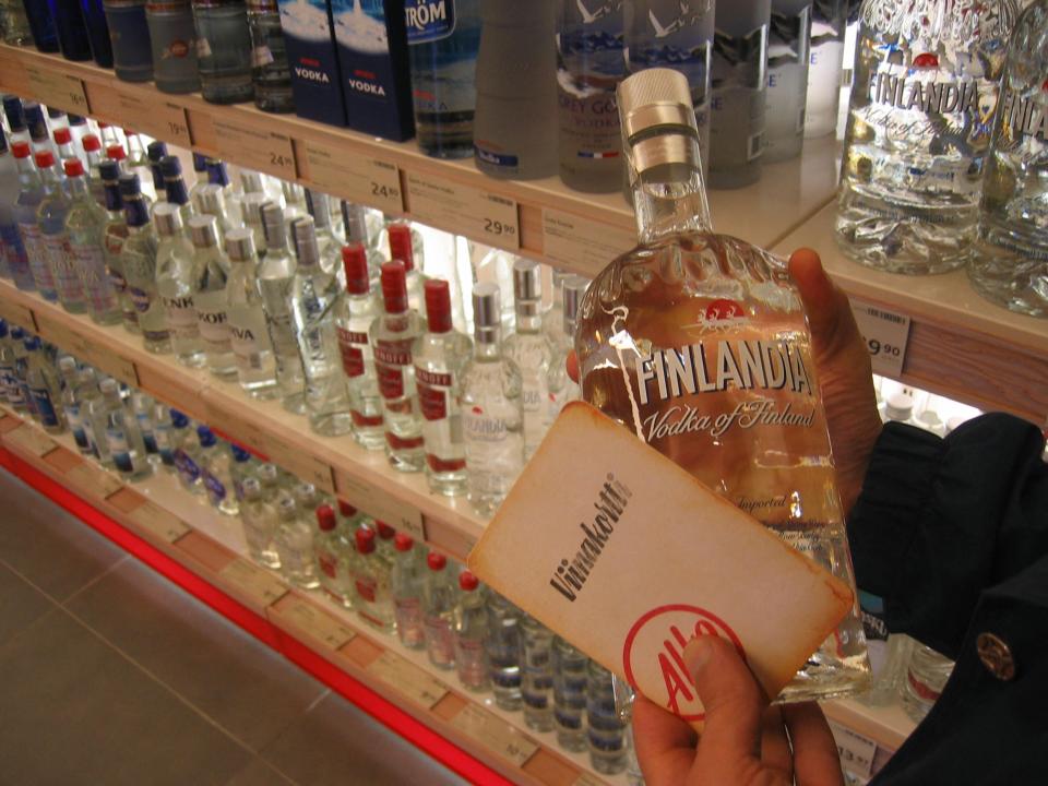 A person holds a bottle of vodka at Alko, the Finnish national liquor store.