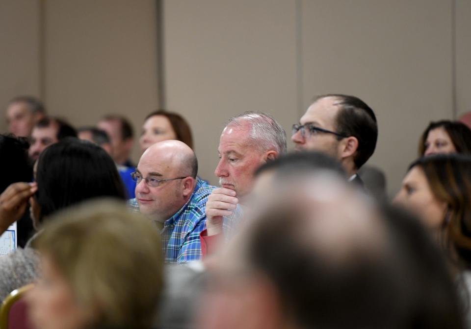Members of the Massillon WestStark Chamber of Commerce listen Friday to U.S. Reps. Emilia Sykes, D-Akron, and Bill Johnson, R-Marietta, discuss small business initiatives and detail their reaction to the Feb. 3 East Palestine train derailment.