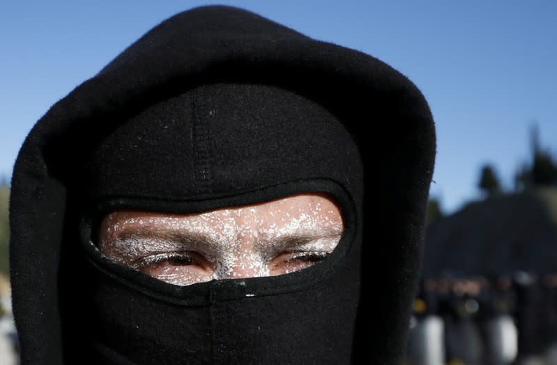 A man looks on as members of Catalan protest group Democratic Tsunami clash with police officers at the AP-7 highway