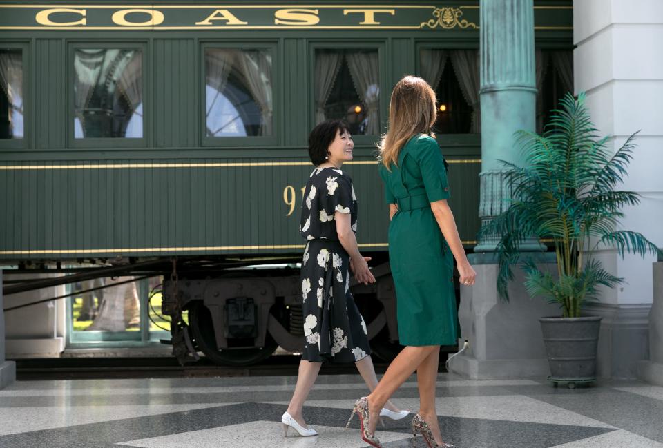First ladies Melania Trump and Akie Abe, wife of Japanese Prime Minister Shinzo Abe walk past Henry Morrison Flagler's private railcar in the Pavillion during their tour of the Flagler Museum, April 18, in Palm Beach, Florida. (Greg Lovett / The Palm Beach Post)