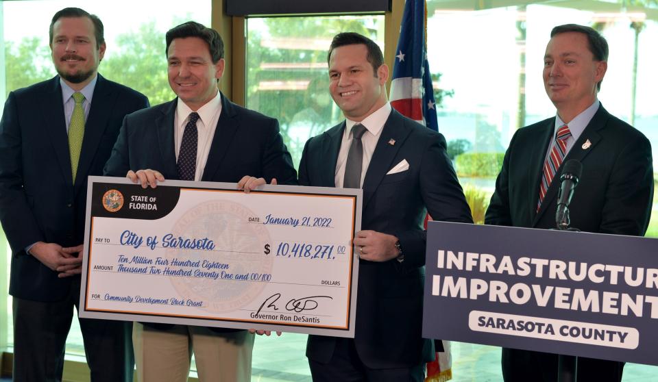 Gov. Ron DeSantis was in Sarasota Friday to announce a $10.4 million grant that has been awarded to The City of Sarasota for several projects involving The Bay Park. Elected officials Florida Rep. James Buchanan, left, Sarasota Mayor Erik Arroyo, second from right, and Florida Rep. Tommy Gregory, right, stand with DeSantis, second from left, to accept a ceremonial check.