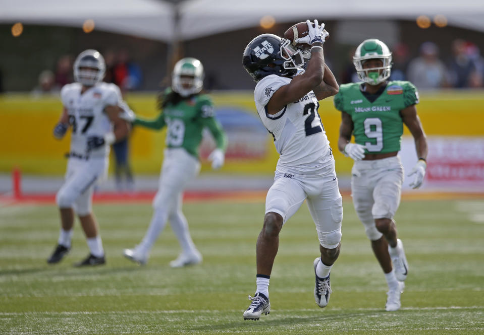Utah State wide receiver Jalen Greene (21) catches a pass ahead of North Texas defensive back Nate Brooks (9) during the first half of the New Mexico Bowl NCAA college football game in Albuquerque, N.M., Saturday, Dec. 15, 2018. (AP Photo/Andres Leighton)