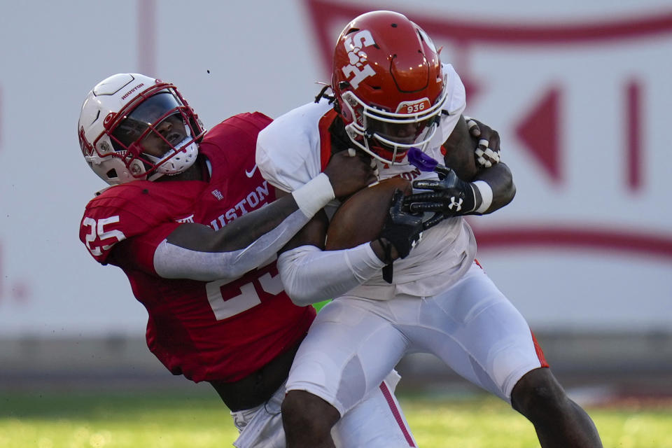 Houston linebacker Jamal Morris, left, tackles Sam Houston State wide receiver Noah Smith during the first half of an NCAA college football game, Saturday, Sept. 23, 2023, in Houston. (AP Photo/Eric Christian Smith)